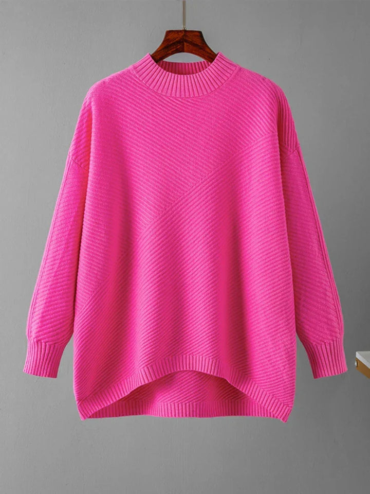 Vibrant pink oversized crew neck sweater displayed on a hanger