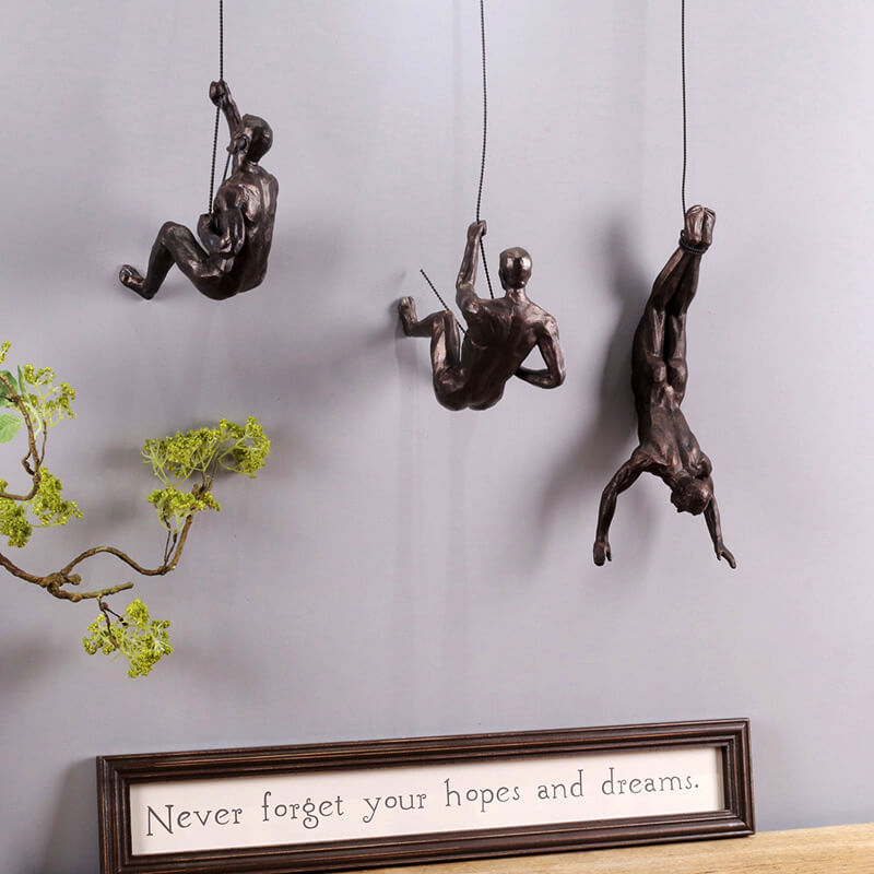 Contemporary home decor wall sculpture depicting a dynamic mountain climber
