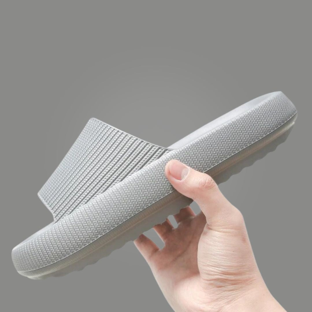 Ergonomic cloud slides resting on surface highlighting ultra soft foam build