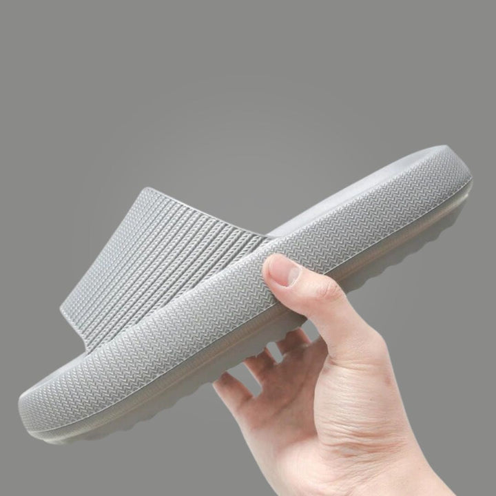 Ergonomic cloud slides resting on surface highlighting ultra soft foam build