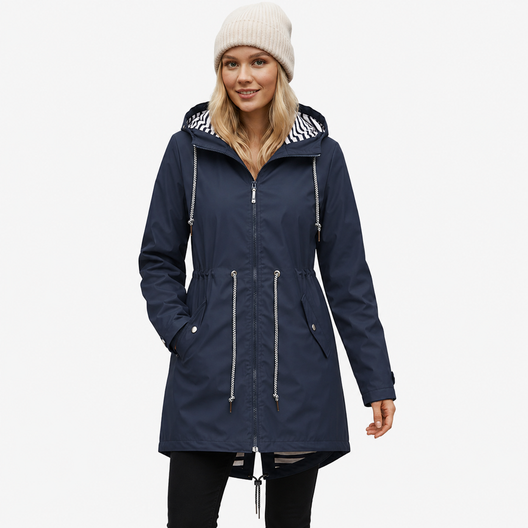 Model wearing a navy blue waterproof rain jacket with striped hood lining
