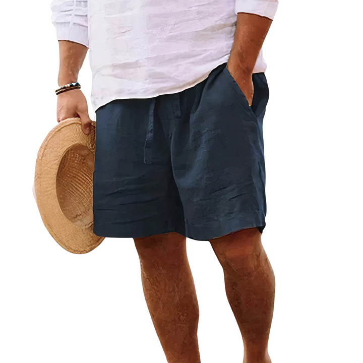 Close-up of man wearing dark blue summer shorts with a drawstring waist