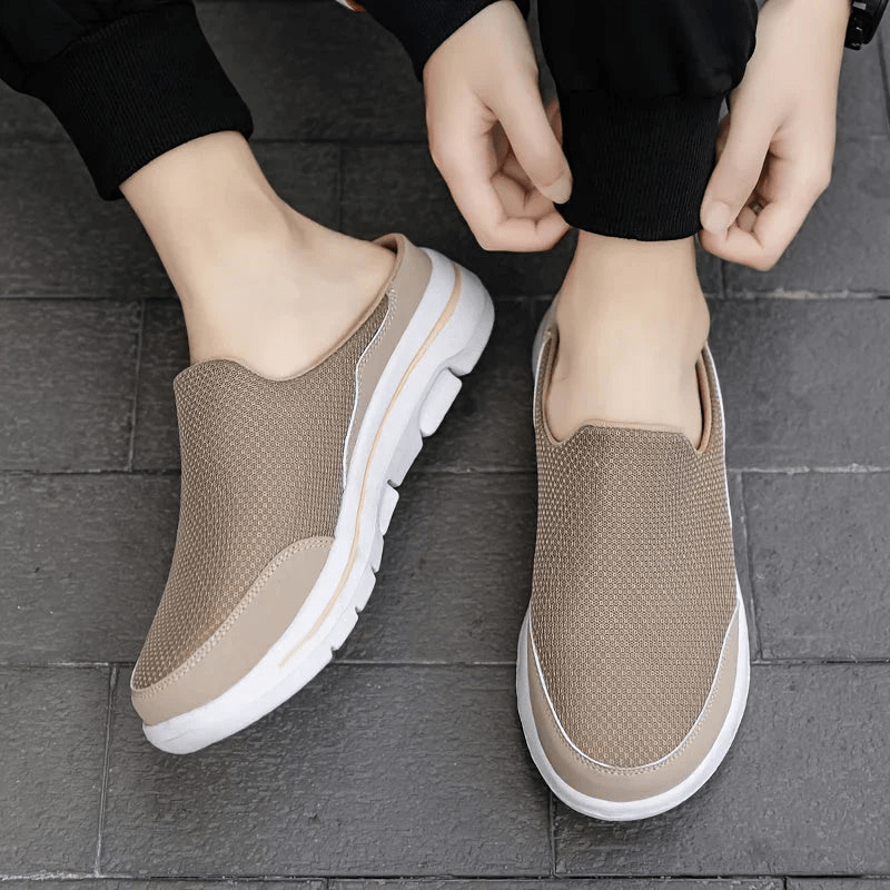 Pair of comfortable mens slippers displayed from the side highlighting lightweight build