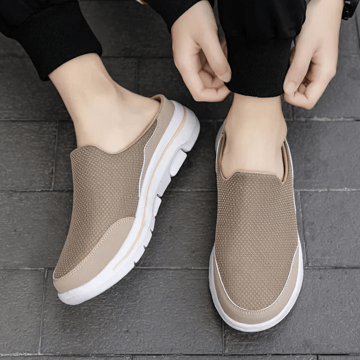 Pair of comfortable mens slippers displayed from the side highlighting lightweight build