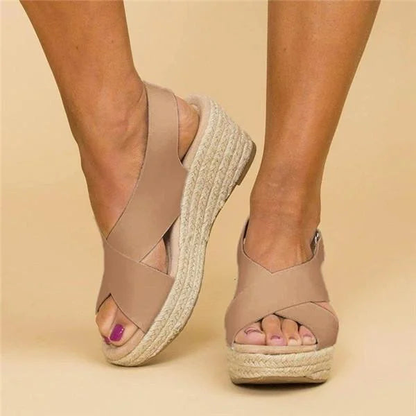 Close up of woman wearing beige wedge espadrilles from the front
