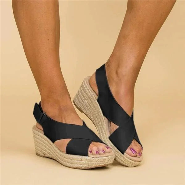 Woman wearing black orthopedic wedge espadrilles sideways view
