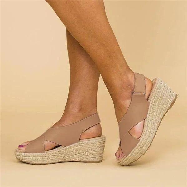 Woman wearing beige orthopedic wedge espadrilles sideways view