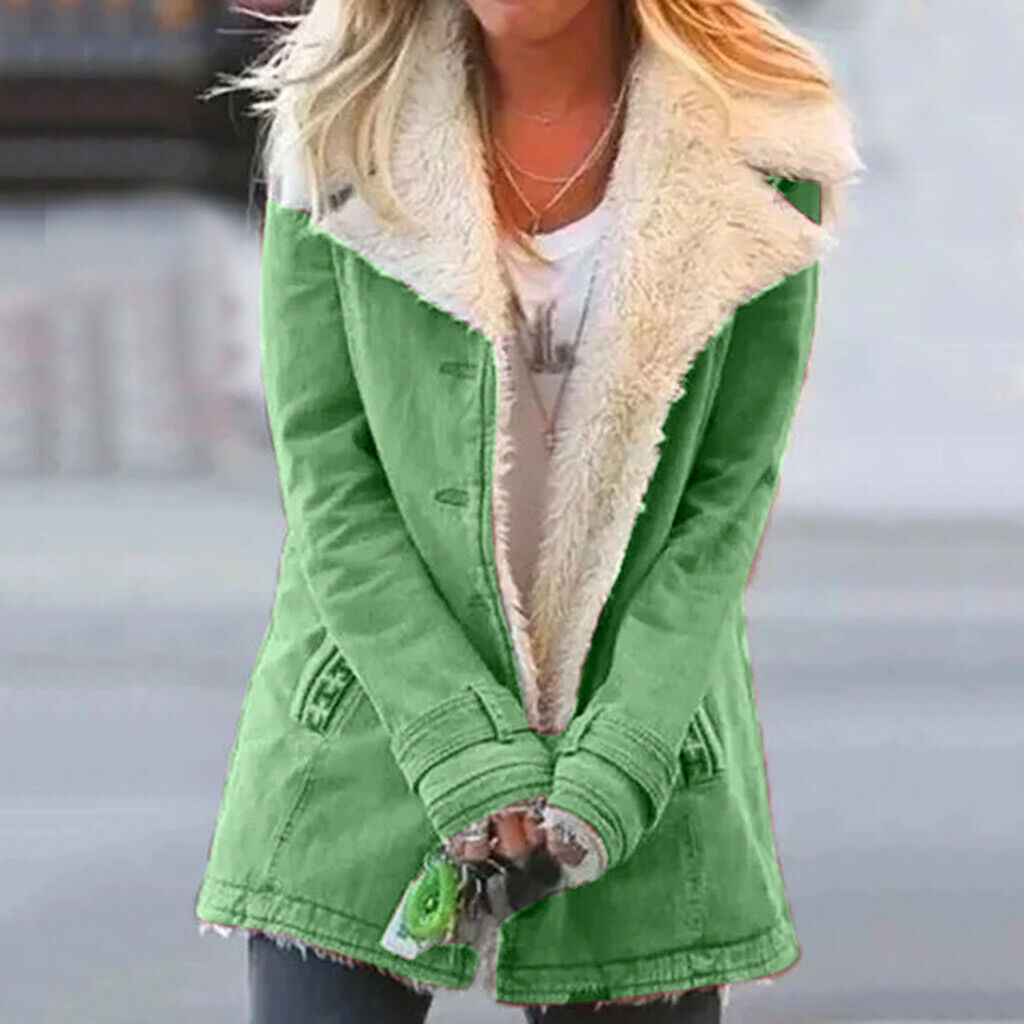 Woman wearing green thermal winter jacket with plush collar