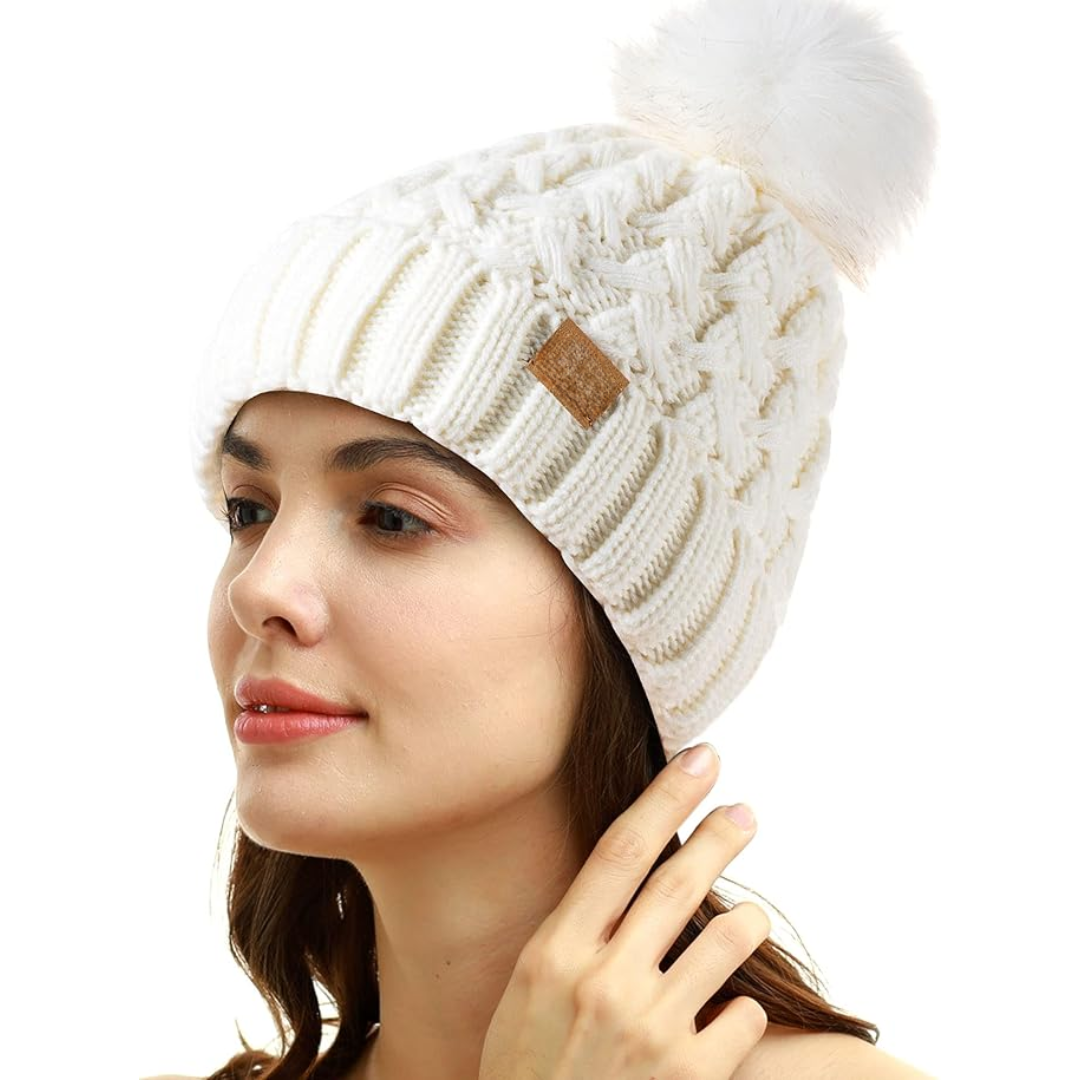 Woman wearing a clean white winter pom beanie with fluffy pom-pom