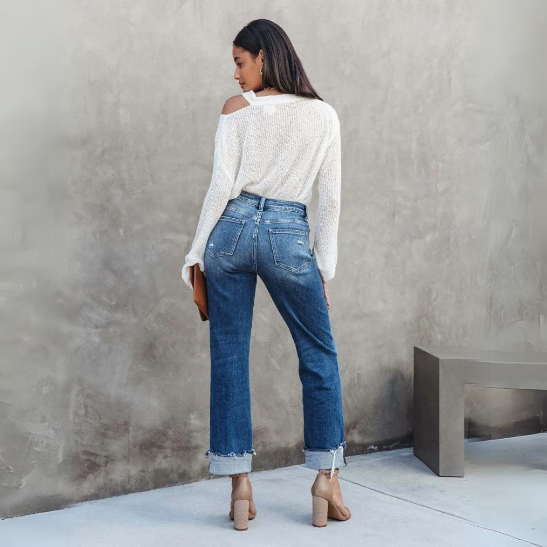 Back view of a woman wearing blue high-waisted relaxed fit jeans