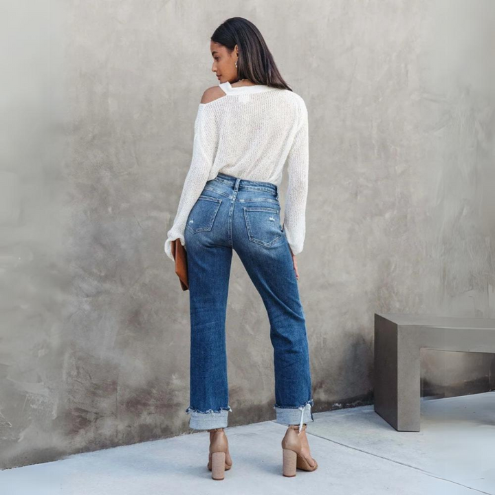 Back view of a woman wearing blue high-waisted relaxed fit jeans