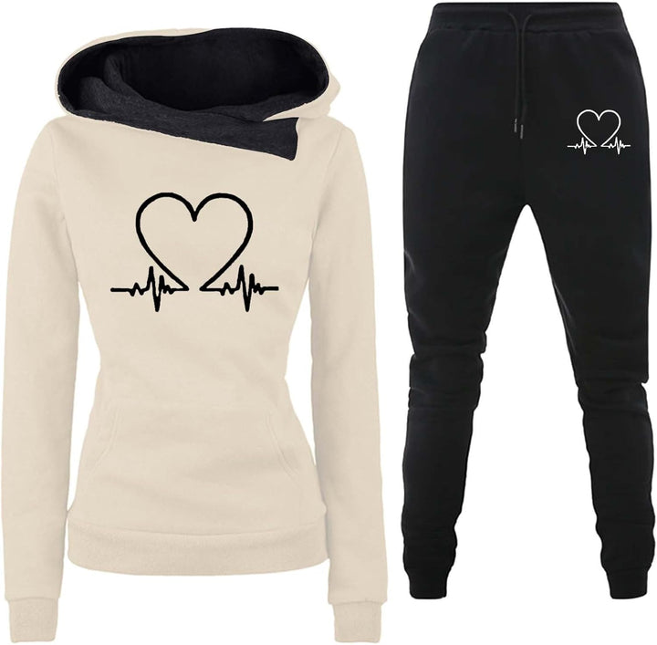 Beige hoodie with heart graphic displayed alongside black matching trousers.