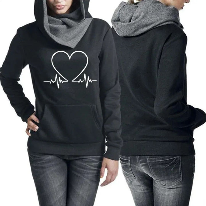 Woman wearing a black two-piece tracksuit from front and back angles.