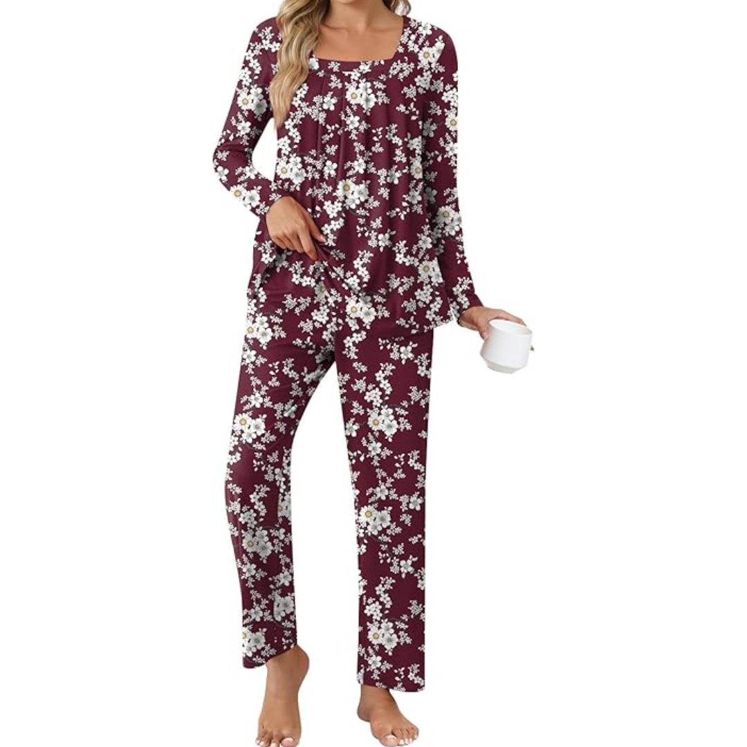 Woman wearing burgundy floral print lounge pyjama set holding a white mug