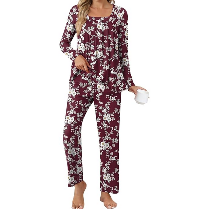 Woman wearing burgundy floral print lounge pyjama set holding a white mug