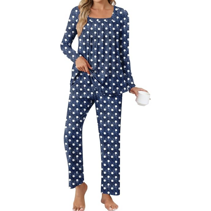 Woman wearing blue polka dot lounge pyjama set holding a white mug
