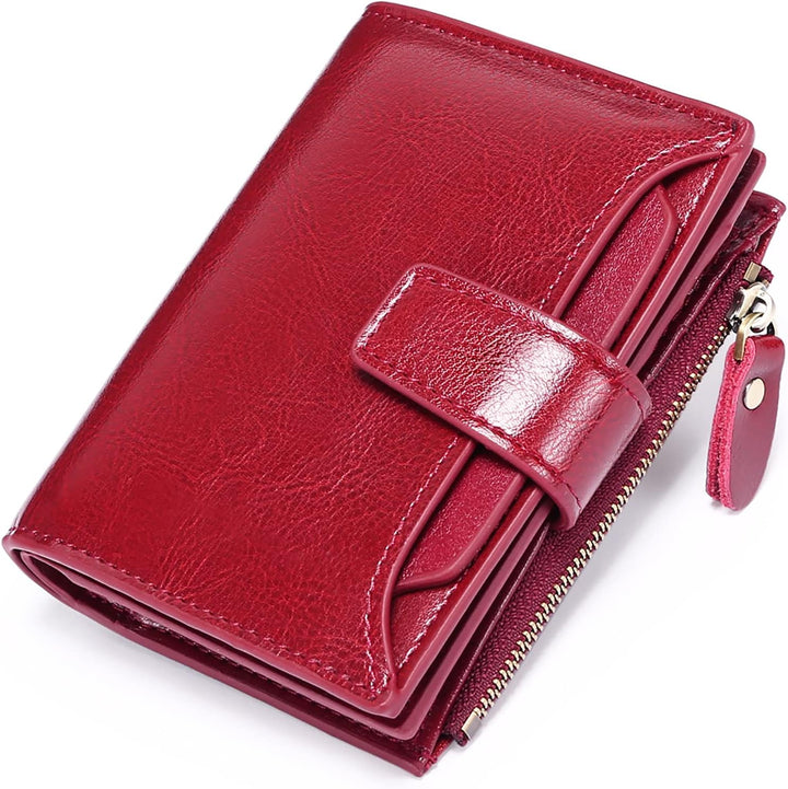Womens compact multi-pocket wallet showing front snap closure and soft leather texture