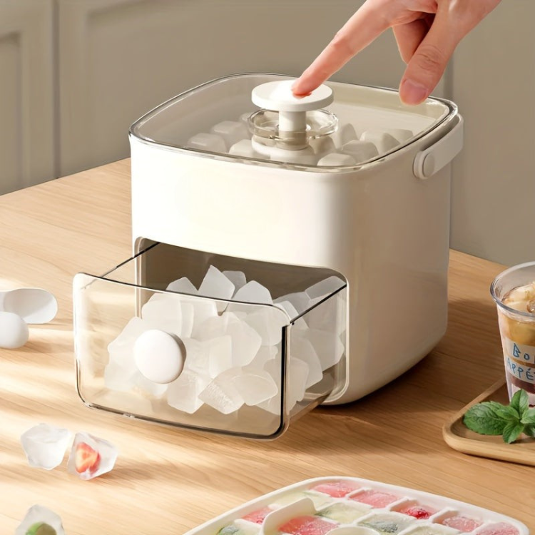 Compact white ice maker with pull-out drawer showing ice cubes on a wooden table