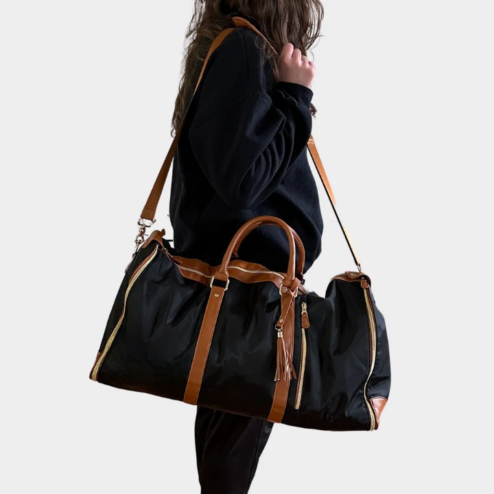 Flat lay of the travel garment bag completely unzipped to reveal its innovative layout