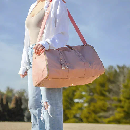 Side view of the water resistant travel duffel bag highlighting durable handles and hardware