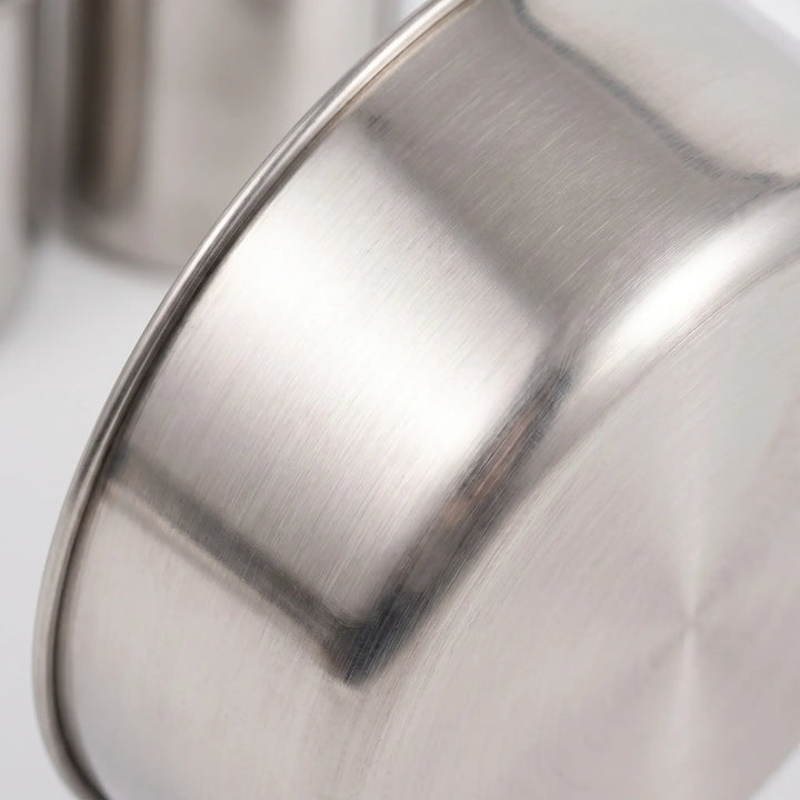 Close-up view showing the polished brushed texture and curved rim of a stainless steel pot