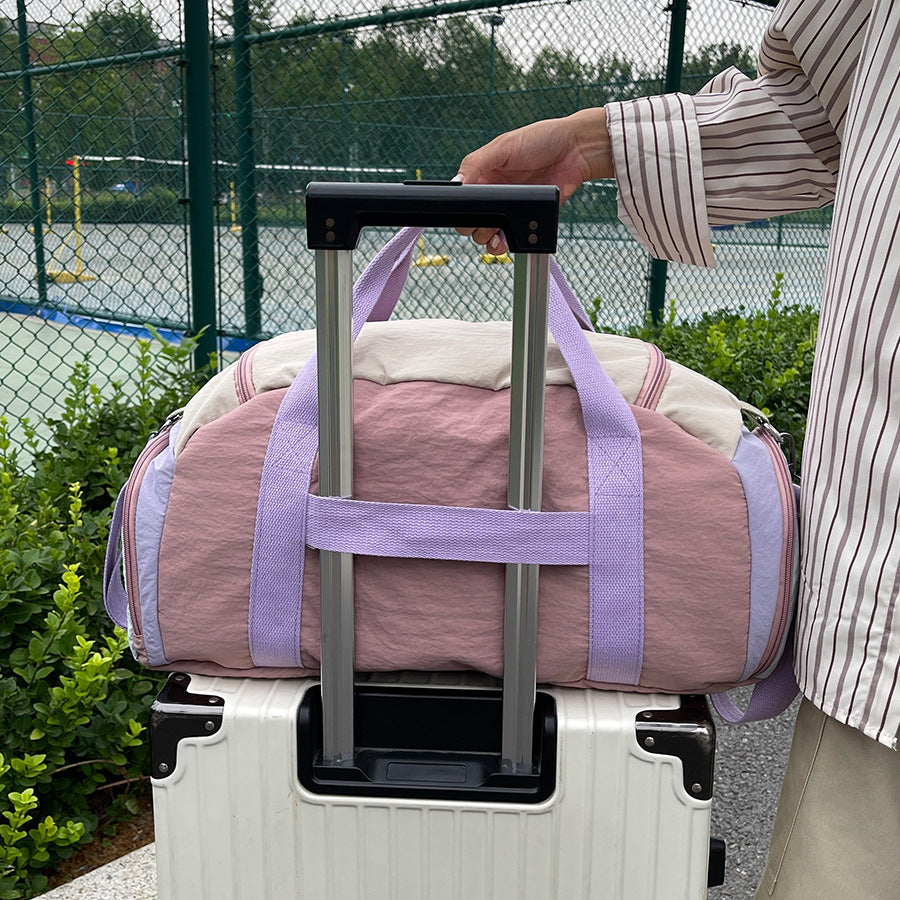 Compact sports duffle bag displaying padded handle and grip