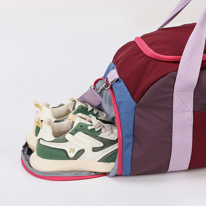Travel bag featuring adjustable shoulder strap and metal hardware