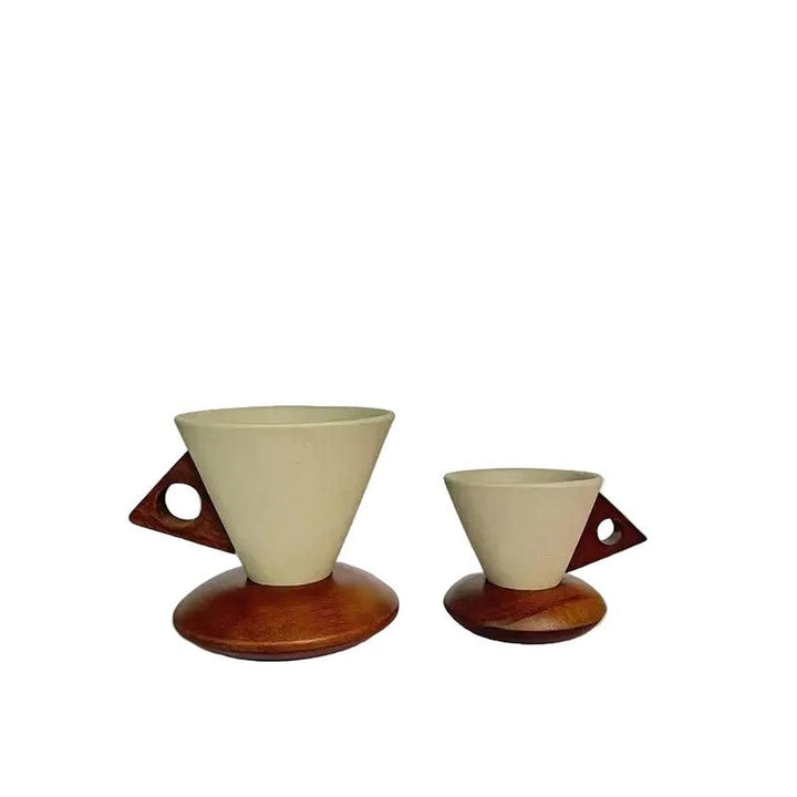 Two conical coffee cups with matching wooden coasters displayed side by side