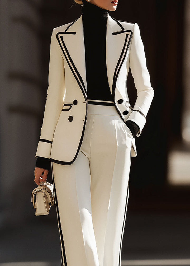 Detailed shot of the elegant lapel piping and double-breasted button closure