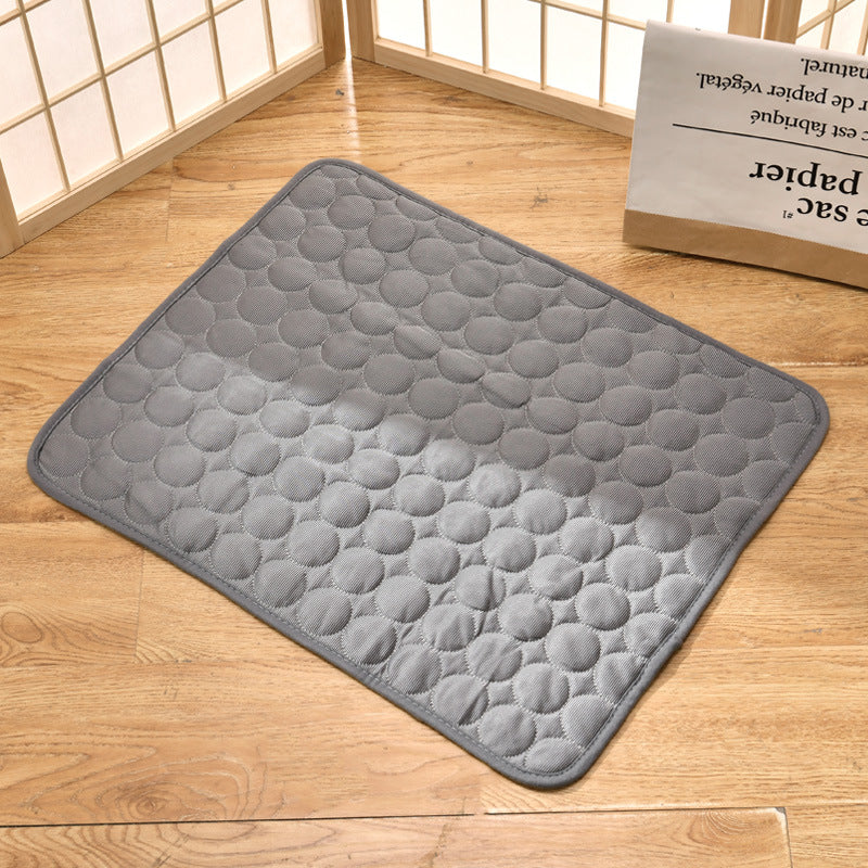 Top view of light grey pet cooling mat showing circular quilted pattern