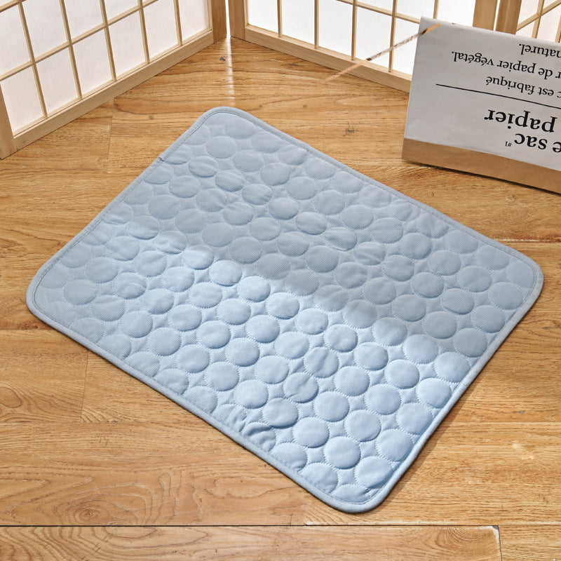 Light blue pet cooling mat displayed on a wooden surface