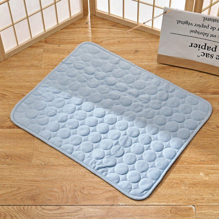 Light blue pet cooling mat displayed on a wooden surface