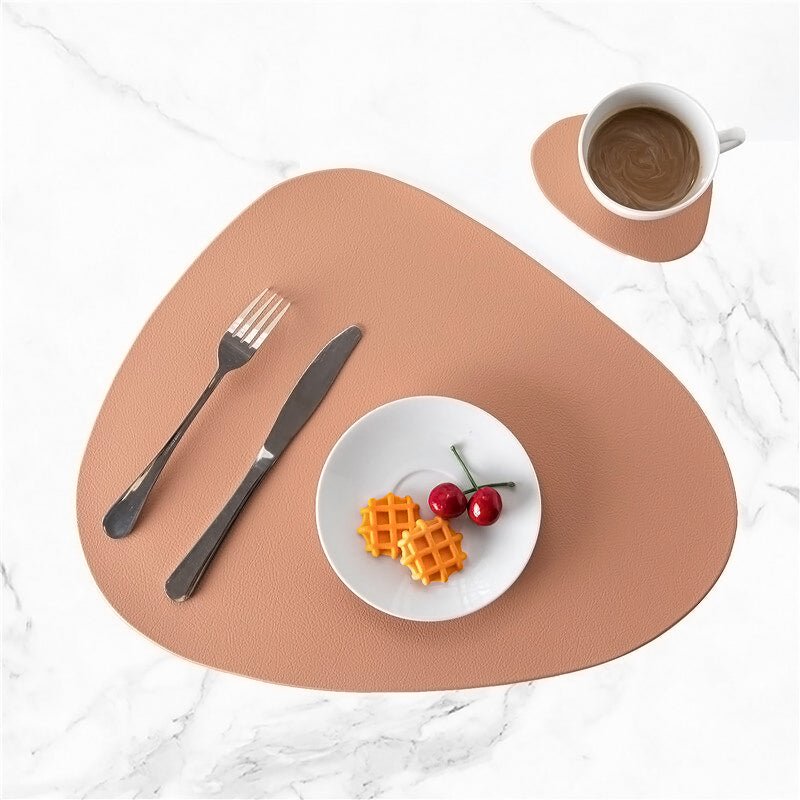 Pink modern table placemat and coaster set on white marble with small white plate and cup