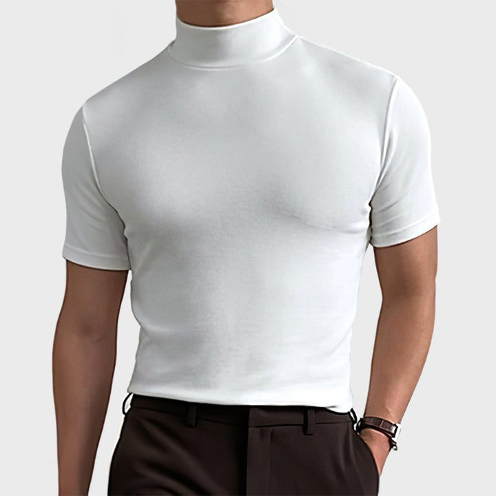 Close-up of a man in a solid white stretch tee with a fitted silhouette