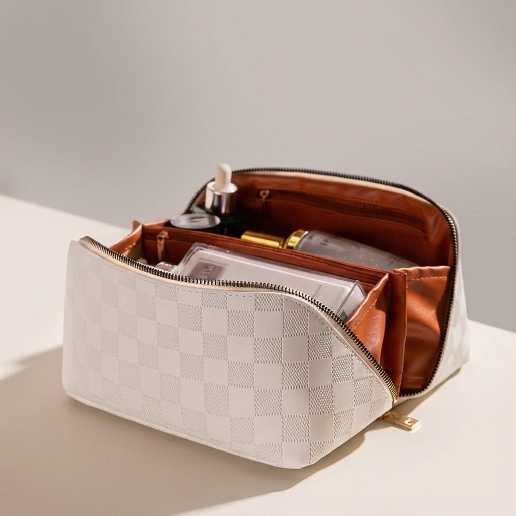 Angle view of the open cream cosmetic bag with organized beauty products inside
