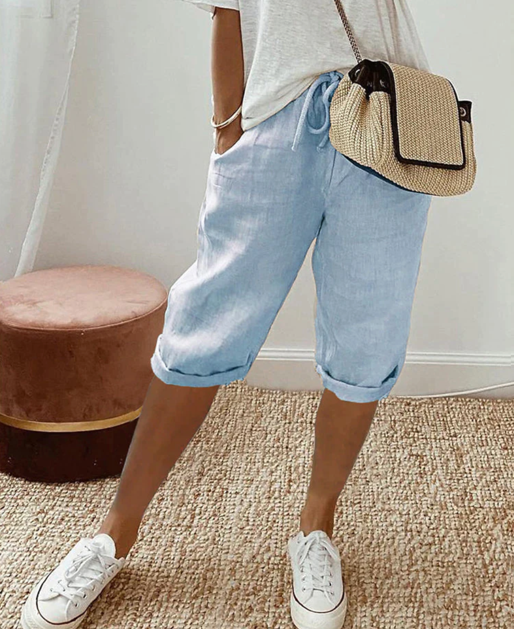 Woman wearing blue casual drawstring shorts with white sneakers