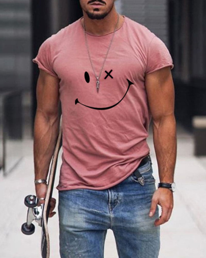 Man wearing a pink short-sleeve t-shirt with a smiley face print