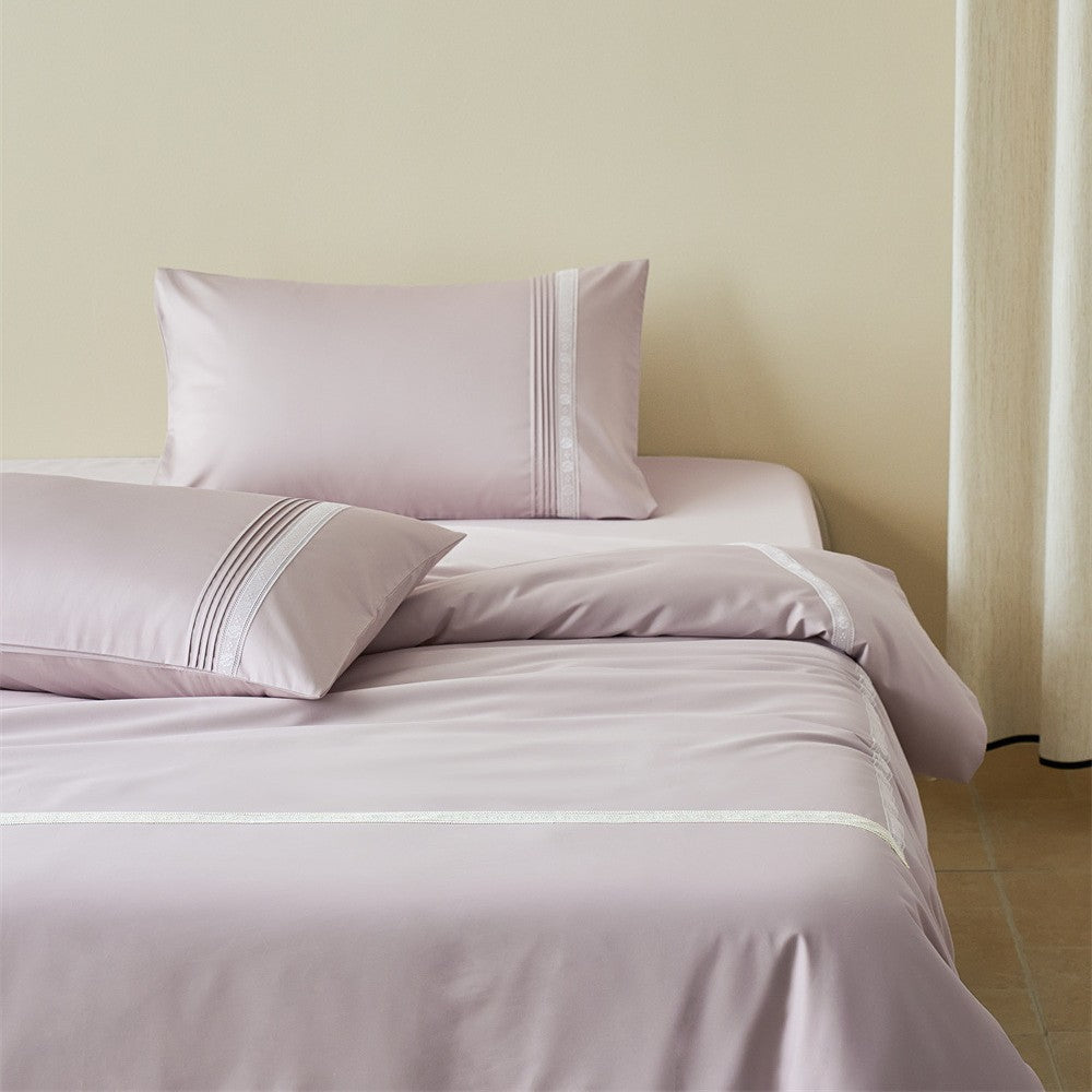 Oatmeal lilac bedding set with fine lace trim on bed