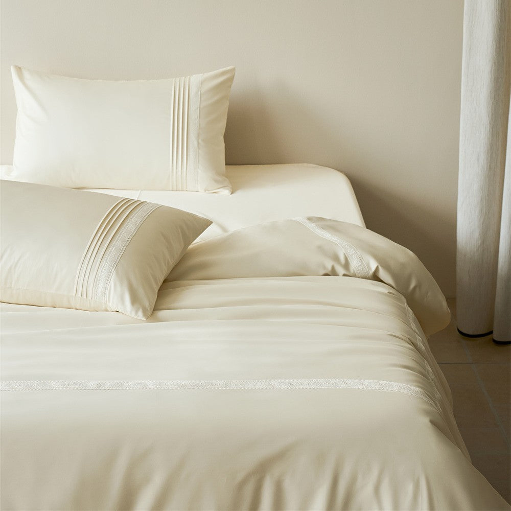 Cream white bedding set with subtle stitching and lace