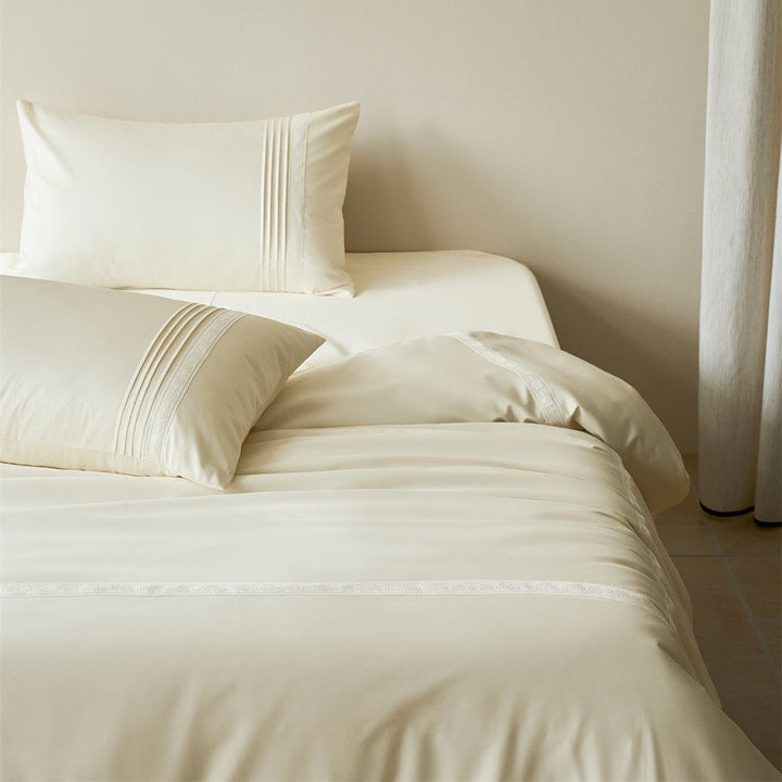 Cream white bedding set with subtle stitching and lace