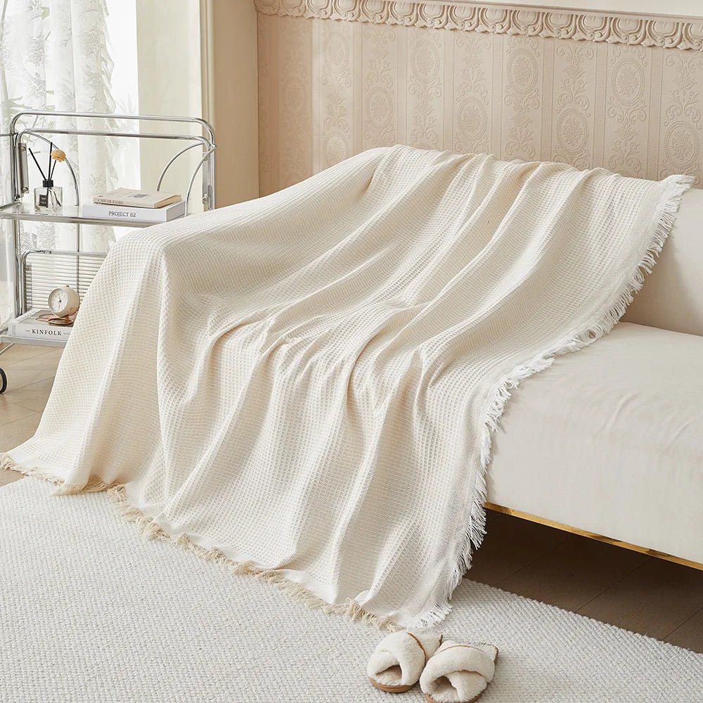 Close-up of breathable fabric texture on a neutral beige sofa protector