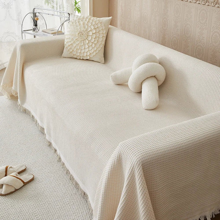 Beige breathable sofa slipcover draped over a living room couch