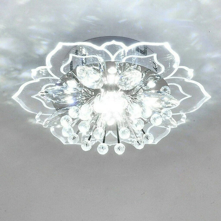 Close-up view of the glittering crystal petals and gold accents on the ceiling light