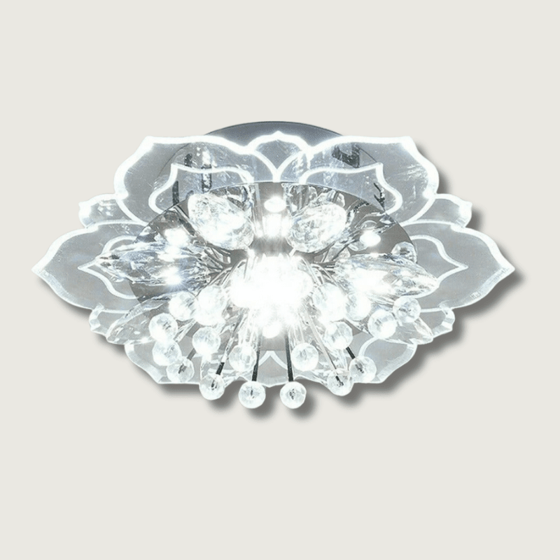 Modern flower-shaped crystal LED chandelier lit up in white against a neutral background