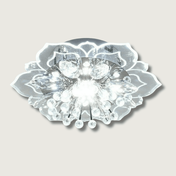 Modern flower-shaped crystal LED chandelier lit up in white against a neutral background