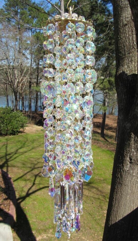 Hanging multicolored crystal wind chime in a sunny garden setting