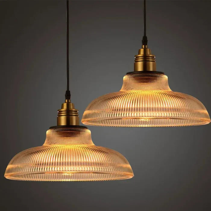 Two CrystalLoom glass pendant lights in amber and transparent hanging side by side
