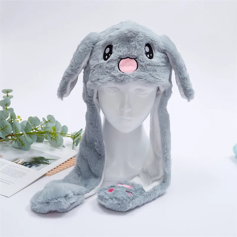 Gray rabbit plush moving ear hat displayed on a mannequin head