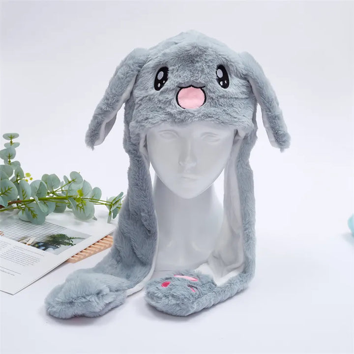 Gray rabbit plush moving ear hat displayed on a mannequin head