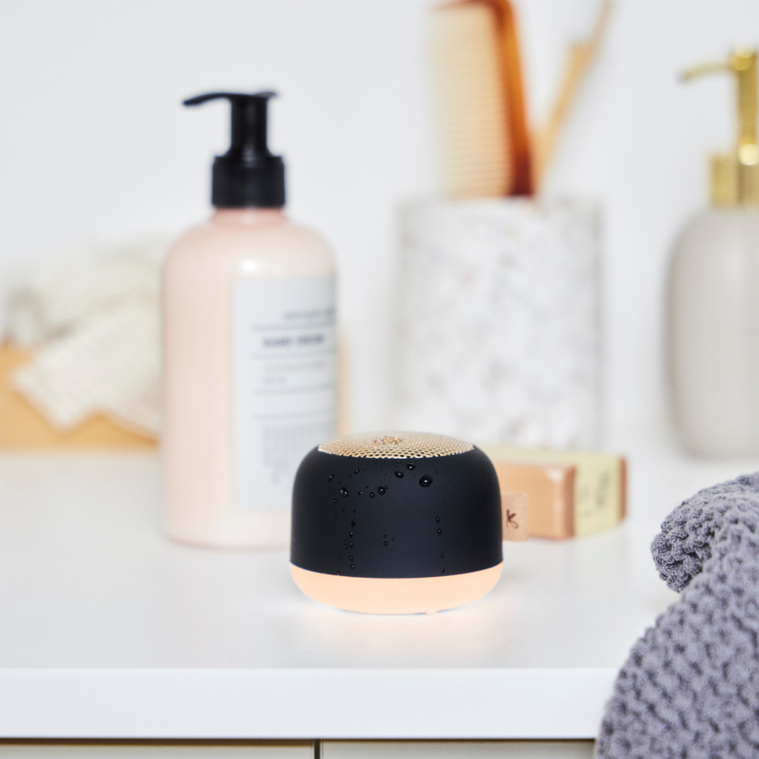 Compact wireless shower speaker featuring vibrant LED mood lighting effects